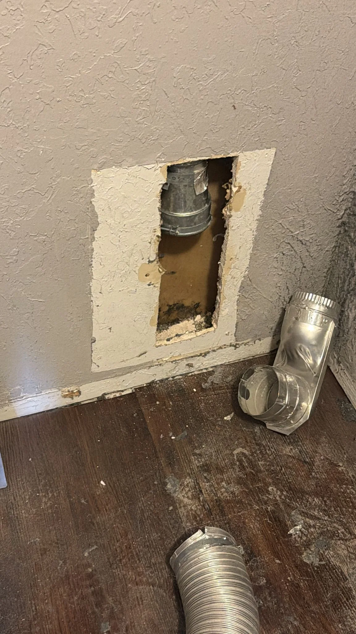 Supplied work photograph showing an accessible dryer vent connection