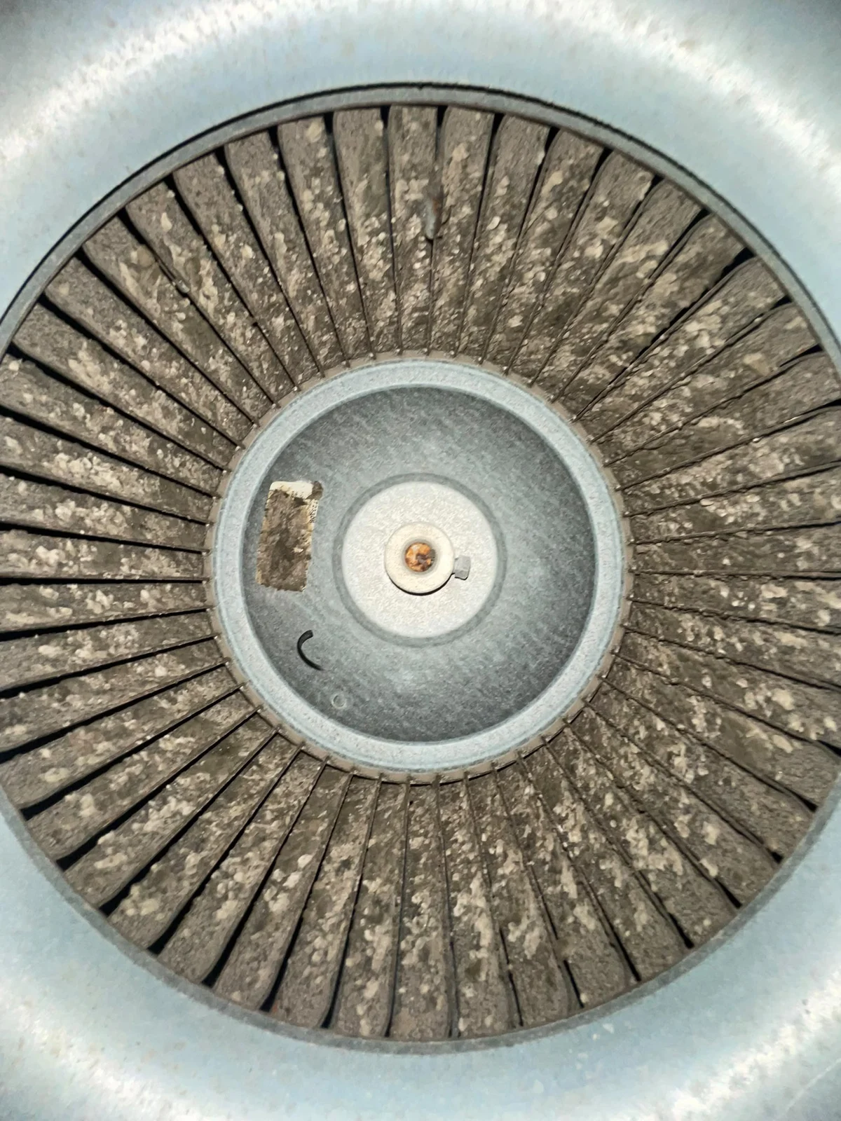 Client photograph of a blower wheel with visible deposits on its blades