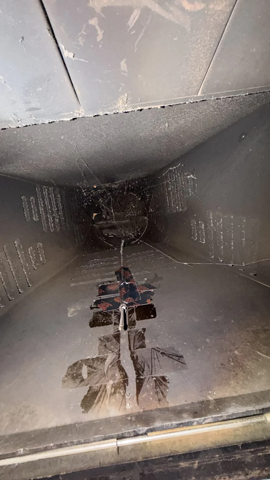Client photograph of deposits around the fireplace throat and damper area