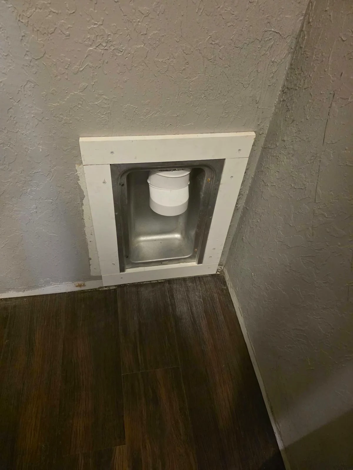 Client photograph of the matching dryer connection with an installed recessed box and trim