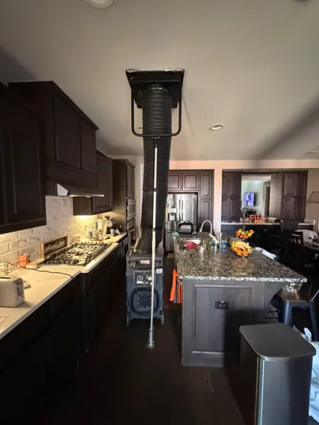Negative-pressure machine connected to an overhead grille